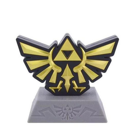 Mini lampada a forma di simbolo di Hyrule dal videogioco Zelda, colore oro con base grigia.