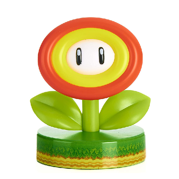 Mini lampada a pile, a forma di fiore tratto dal videogioco Super Mario di Nintendo. Colore verde, giallo e arancione.